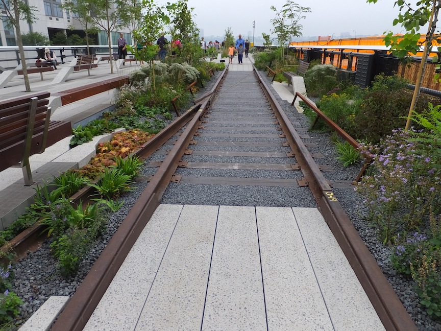 photo of railroad tracks with flowers on high line park
